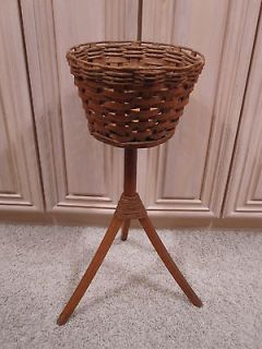 Vintage brown wicker woven basket plant stand with 3 leg pedestal