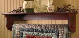   red finishe wall shelf with quilt holder an excellent way to display