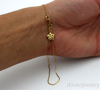This fine box chain with charm anklet is crafted in solid 18K yellow
