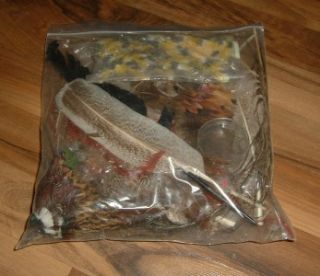 large lot of vintage fly fishing feathers in bag