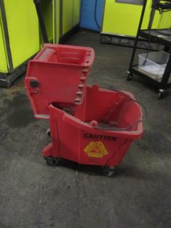 RED MOP BUCKET WITH RINGER ON WHEELS   PRICE REDUCED 35% SEND OFFER