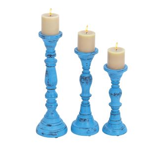 Set Of 3 Wood Candle Holder With Bell Shaped Design Base (Wood Setting: IndoorIncludes: Three (3) candle holdersColor/Finish: Blue Dimensions:18 inches high x 6 inches wide x 6 inches deep 15 inches high x 5 inches wide x 5 inches deep 12 inches high x 5 